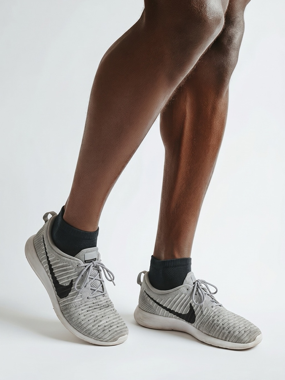Nike Light Gray Roshe Flyknit Sneakers with Black Swoosh